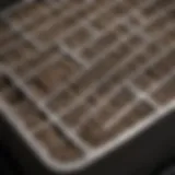 Close-up view of an air conditioning filter showing dirt and debris