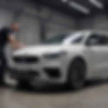 Application of Protective Coating A technician applying a protective coating to a vehicle in a workshop