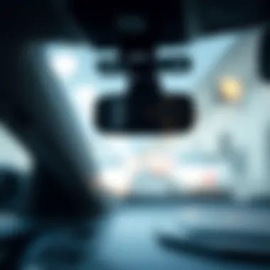 A close-up view of a forward facing vehicle camera mounted on a car windshield.