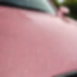 Close-up of a pearlescent pink car wrap showcasing its unique sheen and texture