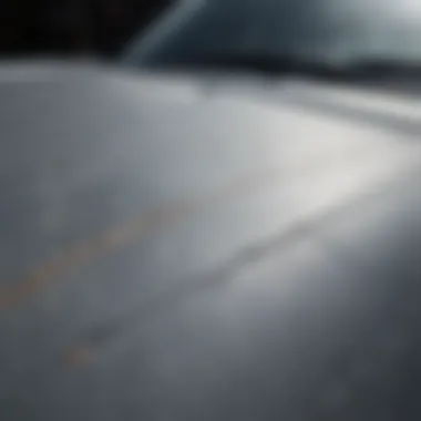 Close-up of a scratched car surface showing key marks