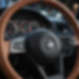 A close-up view of a steering wheel highlighting its intricate design and features.