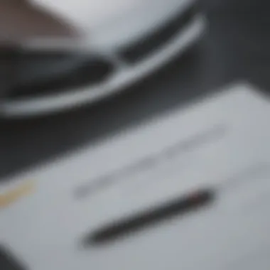 A close-up view of a car lease agreement with a pen on top