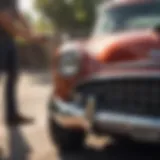 Classic car dusting a vintage vehicle under sunlight