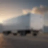 A cargo trailer parked beside a truck, showcasing its robust design.