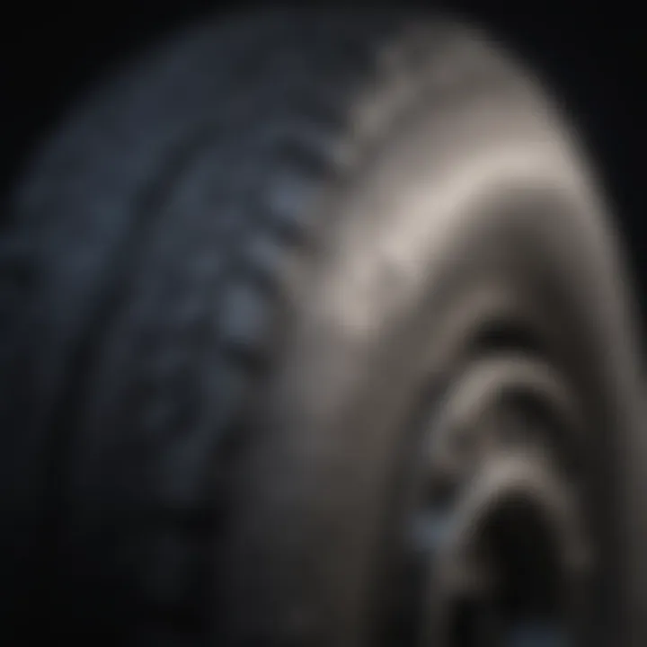 A tire with visible wear patterns highlighting tread depth